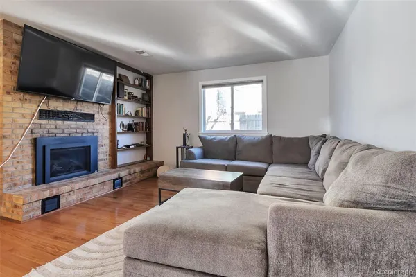 a living room with furniture and a fireplace