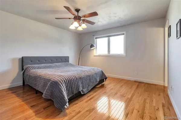 a bedroom with a large bed and a chandelier