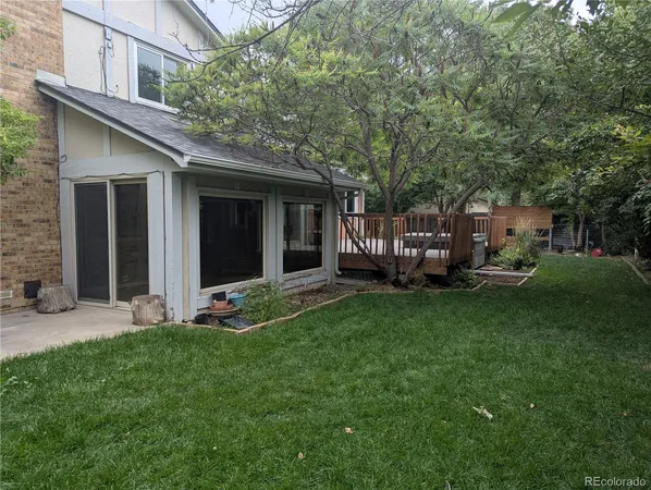 a view of a house with backyard porch and garden