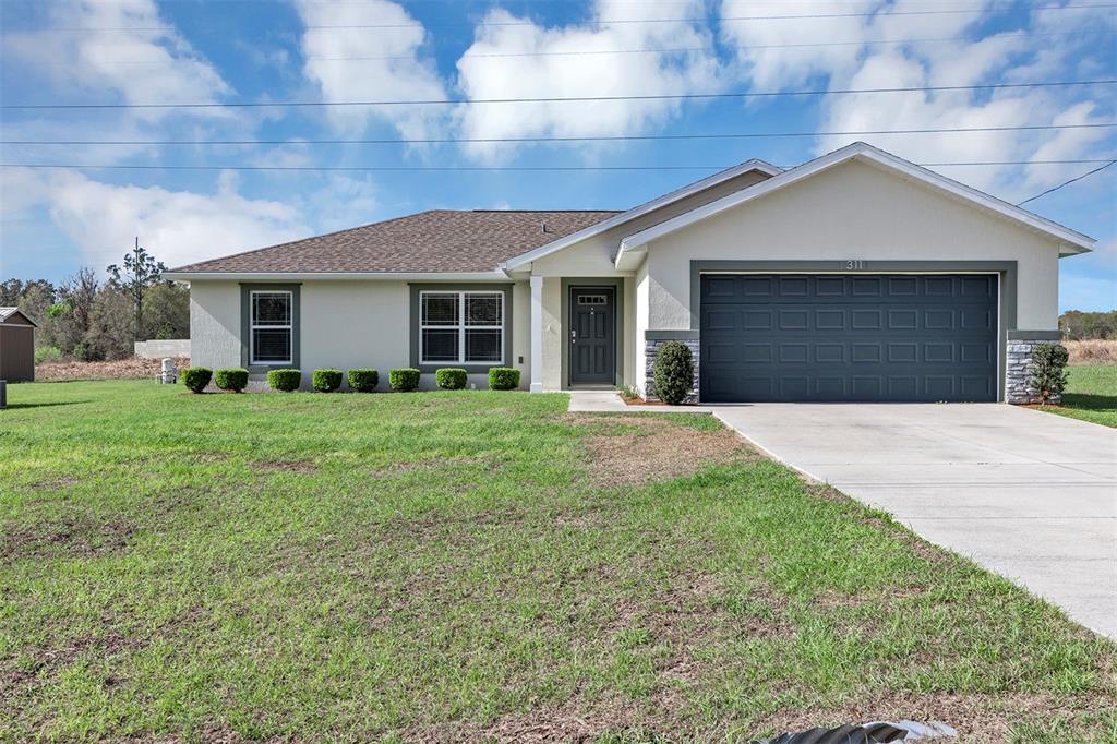 311 Locust Road Ocala, FL 34472 - Photo 1 of 1 a front view of house with yard and green space