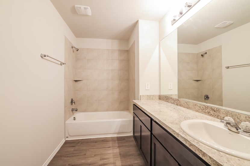 13816 Winding Path Lane Willis, TX 77378 - Photo 4 of 8 a bathroom with a granite countertop sink and a mirror