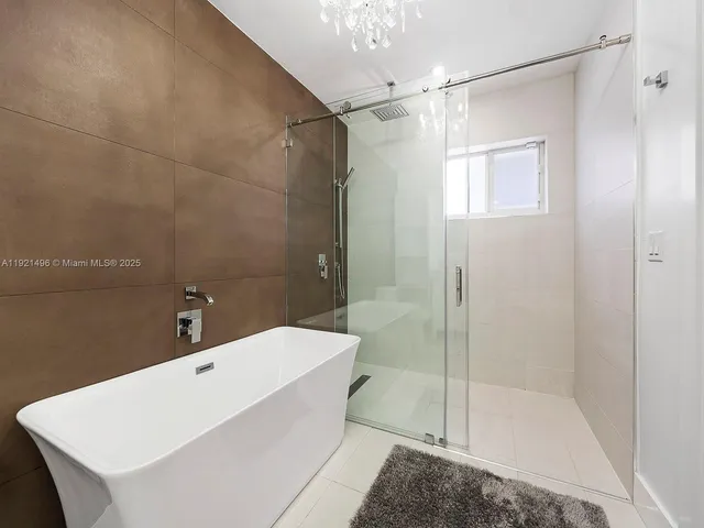 a bathroom with a bathtub and shower