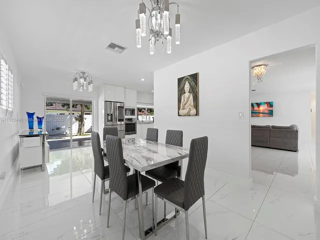a kitchen with stainless steel appliances a refrigerator sink and cabinets