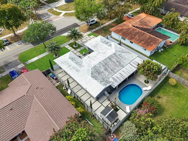 an aerial view of a house with a garden and swimming pool