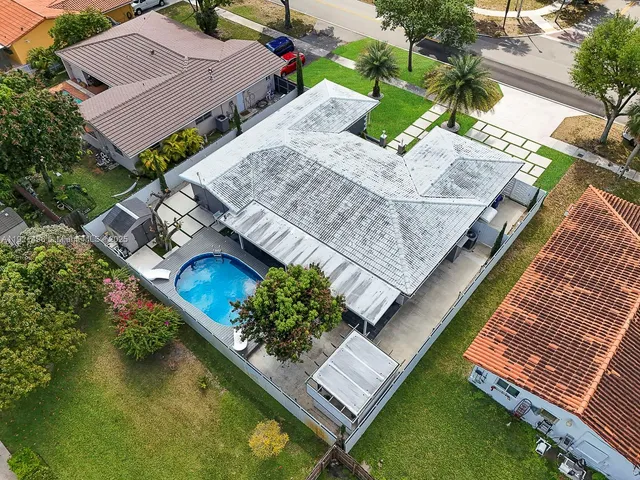 an aerial view of a house with a garden and swimming pool