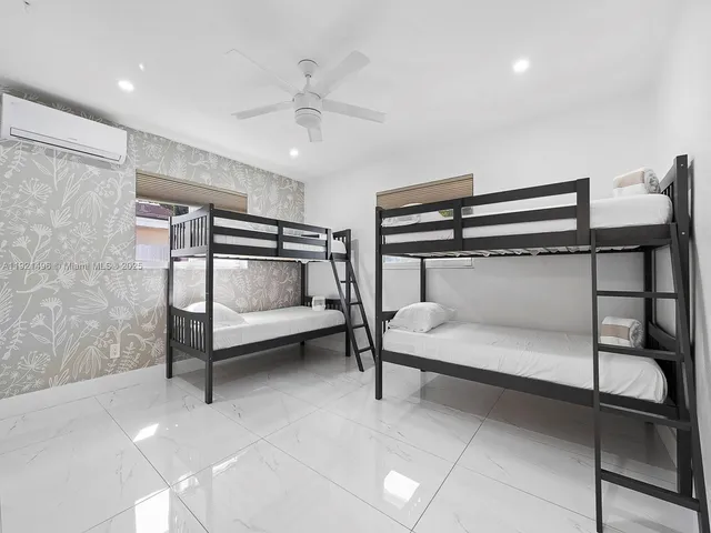 a bedroom with a bunk bed and a chandelier