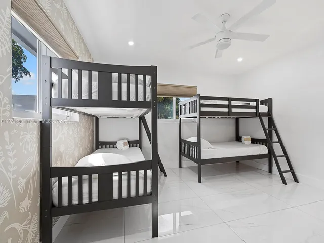 a bedroom with furniture and a window