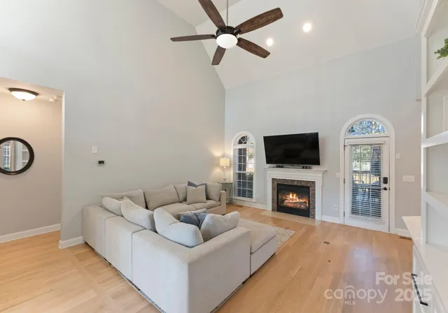 a living room with furniture a fireplace and a flat screen tv