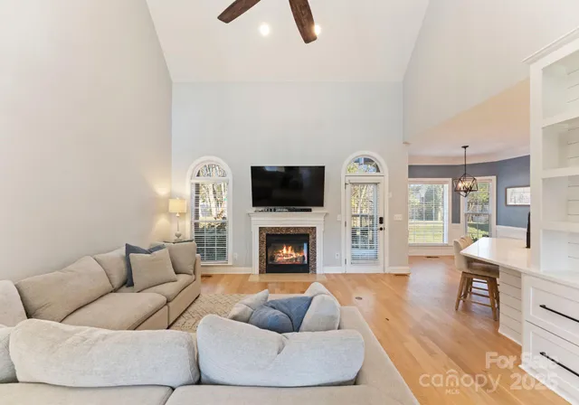 a living room with furniture a fireplace and a flat screen tv