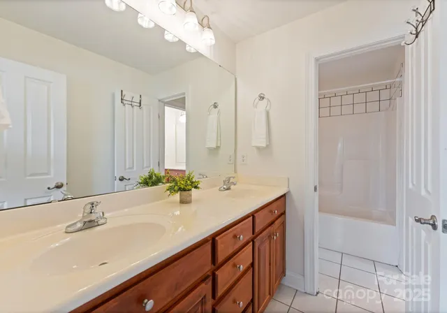 a bathroom with a sink double vanity and a mirror