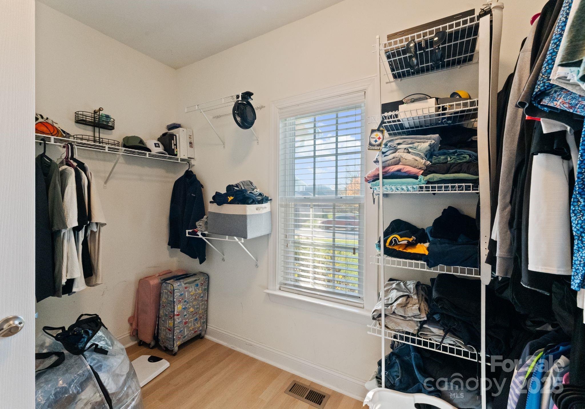 706 King Fredrick Lane Southwest Concord, NC 28027 - Photo 21 of 36 a view of walk in closet with clothes and shoes