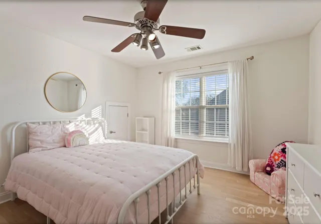 a bedroom with a bed dresser and a window