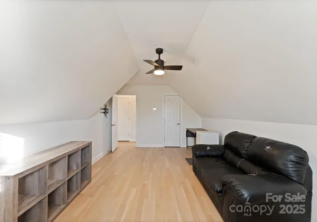 a living room with furniture and a ceiling fan