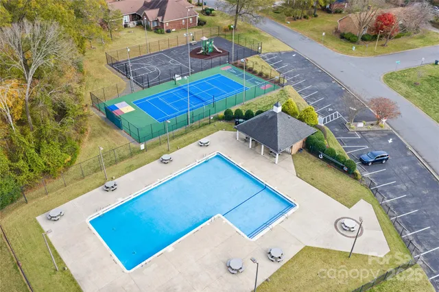an aerial view of a house with a swimming pool