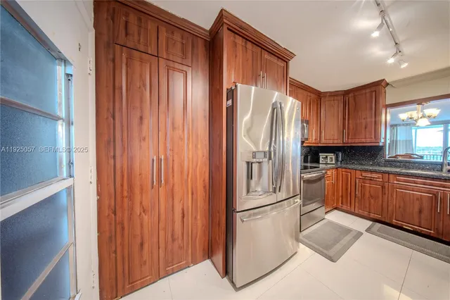 a kitchen with stainless steel appliances granite countertop a refrigerator and a sink