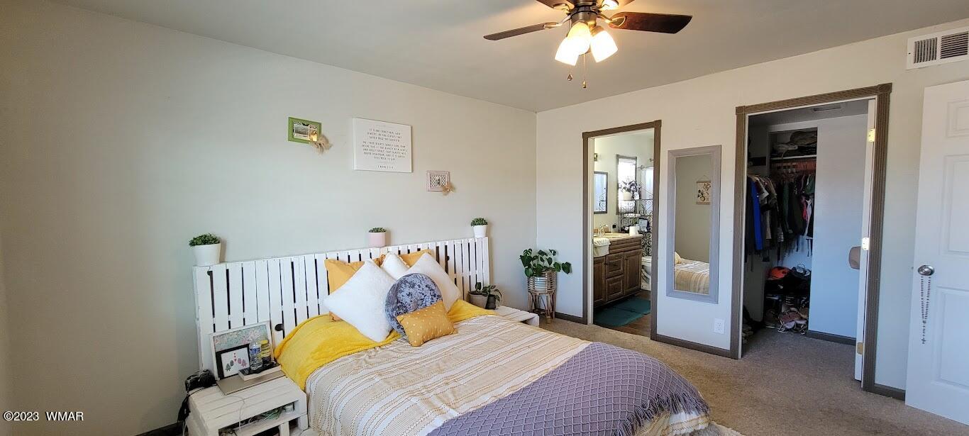 741 South 7th W Street Snowflake, AZ 85937 - Photo 15 of 41 a bedroom with a bed and a chandelier