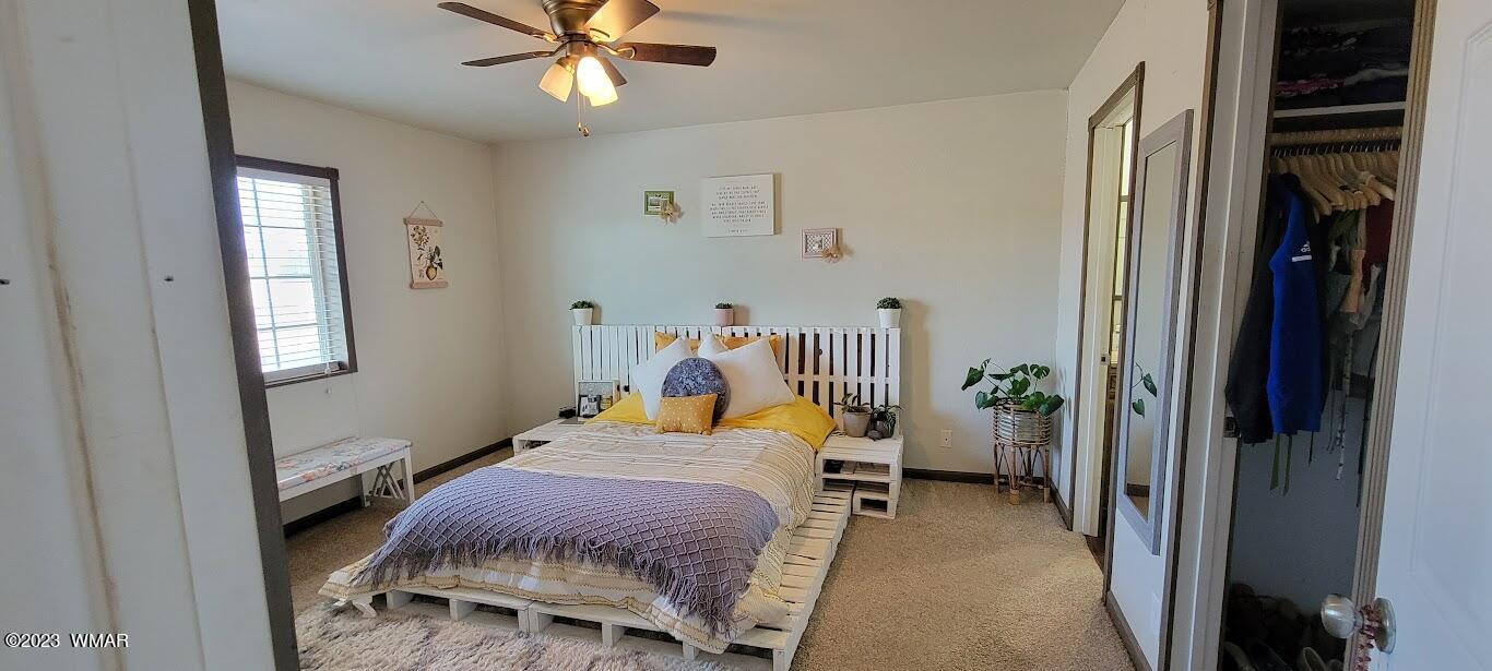 741 South 7th W Street Snowflake, AZ 85937 - Photo 16 of 41 a bedroom with a bed and a chandelier