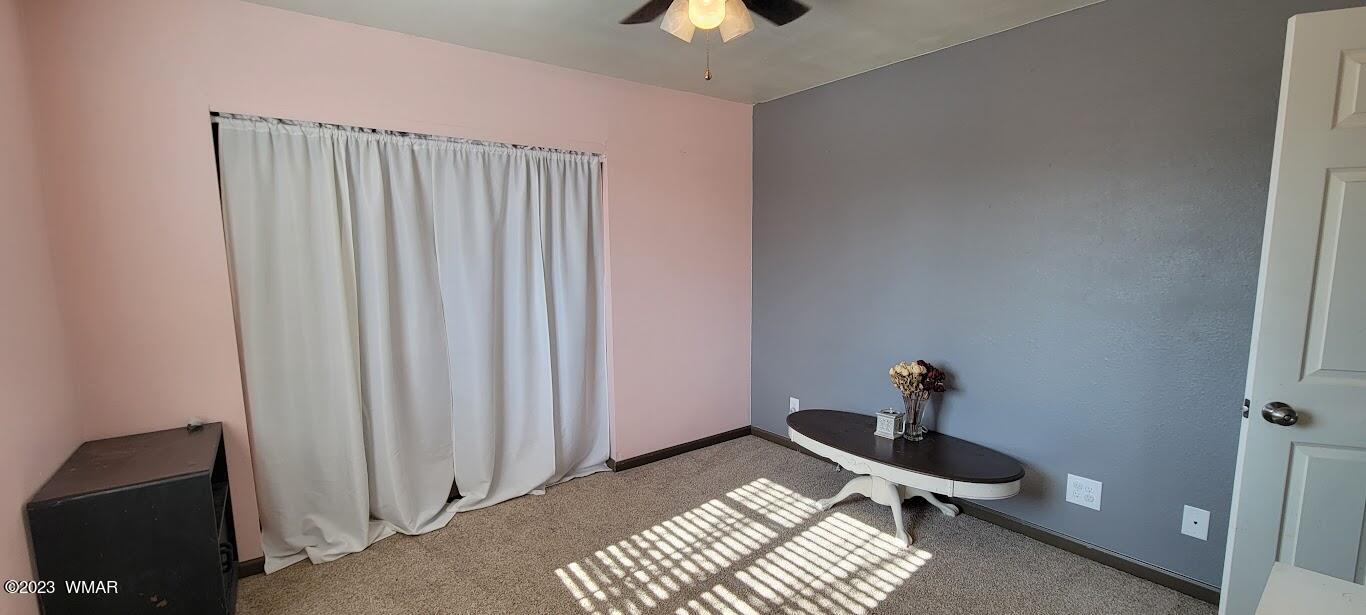 741 South 7th W Street Snowflake, AZ 85937 - Photo 22 of 41 a bedroom with a bed and a chandelier fan
