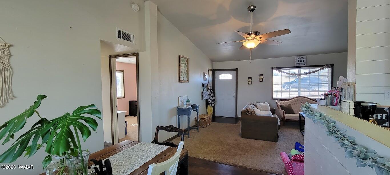 741 South 7th W Street Snowflake, AZ 85937 - Photo 8 of 41 a living room with furniture a chandelier and a potted plant