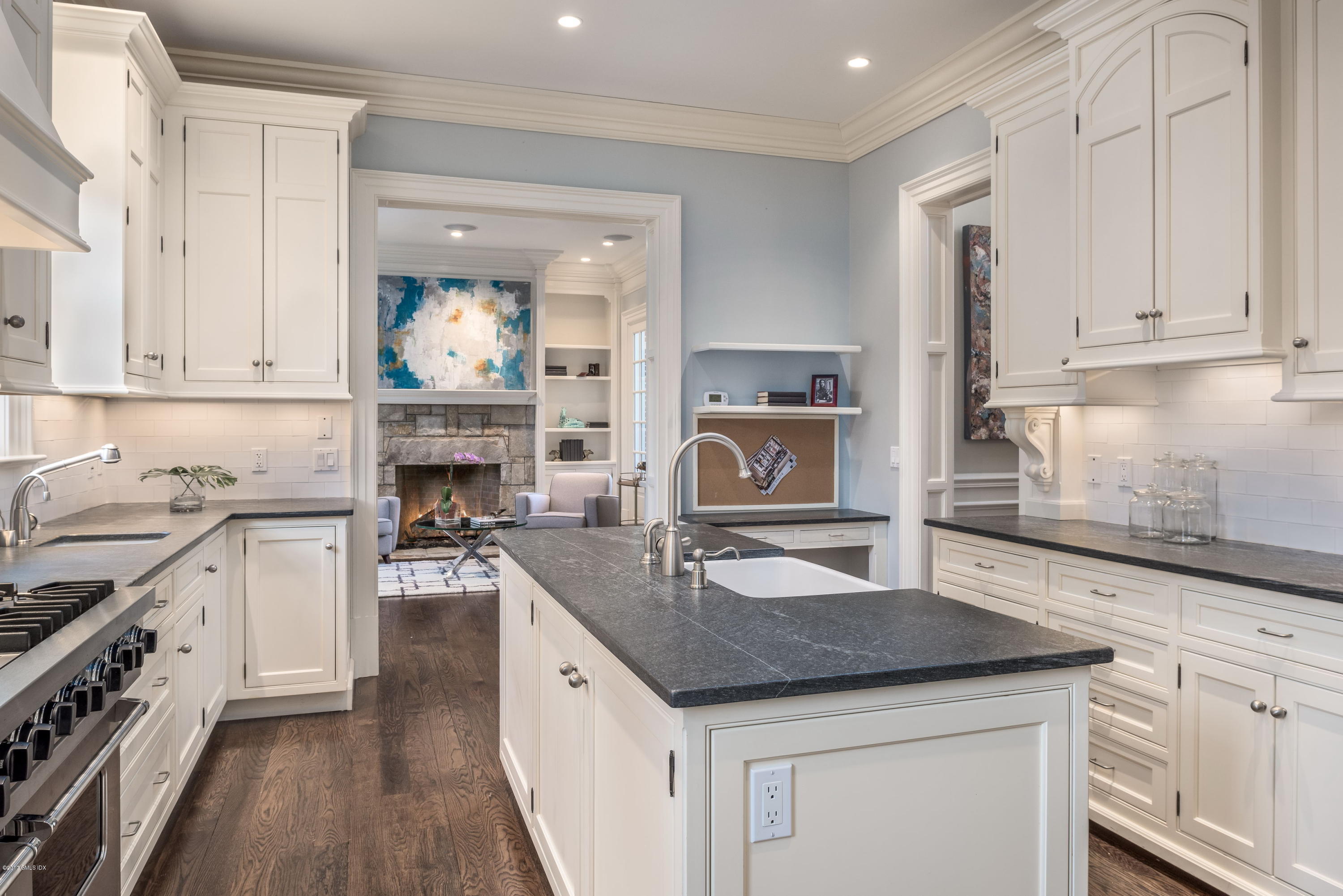 215 Milbank Avenue, Unit E Greenwich, CT 06830 - Photo 7 of 17 a kitchen with granite countertop a sink stove and cabinets