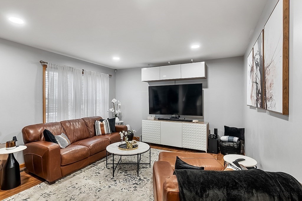 307 Ridge Road, Unit B Revere, MA 02151 - Photo 3 of 26 a living room with furniture and a flat screen tv