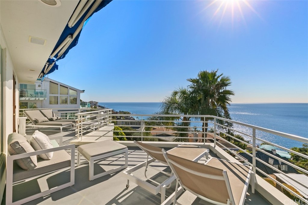 a view of a balcony with furniture and city view