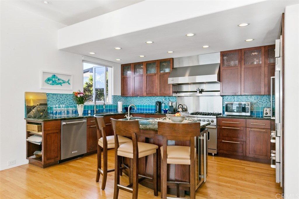 2485 Kilo Way Laguna Beach, CA 92651 - Photo 13 of 35 a kitchen with stainless steel appliances granite countertop table chairs sink and stove