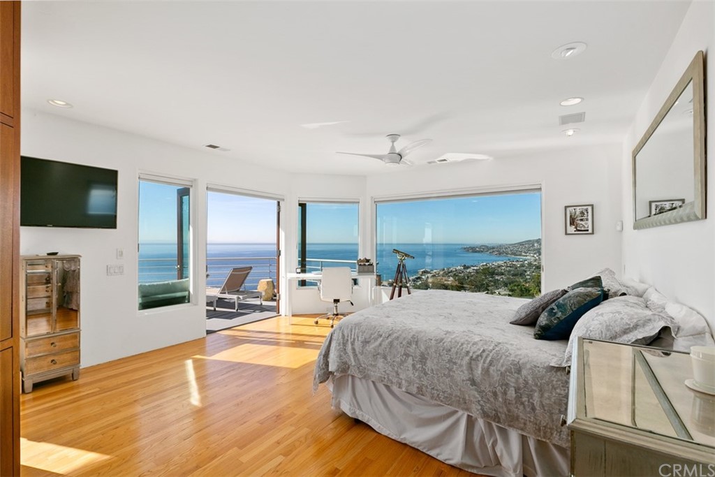 2485 Kilo Way Laguna Beach, CA 92651 - Photo 17 of 35 a spacious bedroom with a bed a couch and a flat screen tv