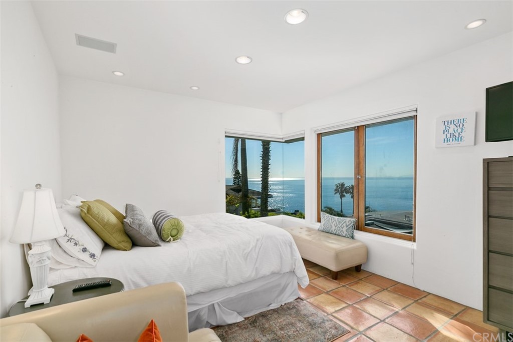 2485 Kilo Way Laguna Beach, CA 92651 - Photo 26 of 35 a bedroom with a bed and glass door
