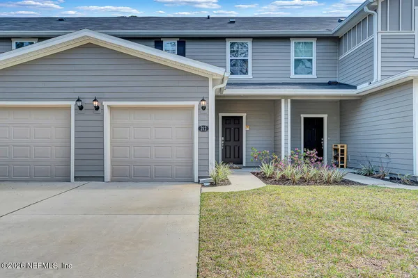a view of house with backyard space and porch