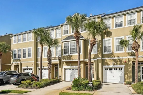 a front view of a residential apartment building with a yard