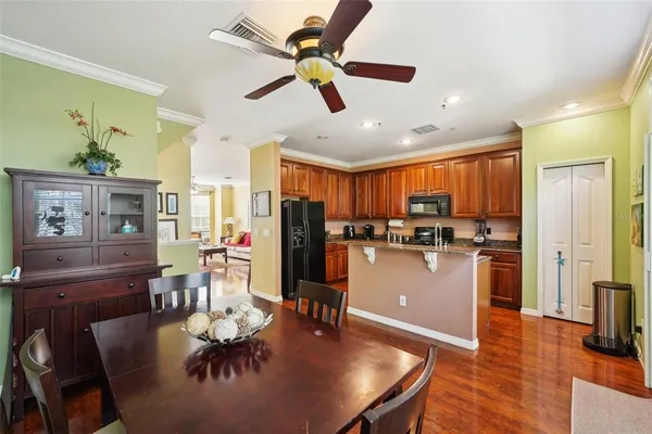 a kitchen with stainless steel appliances granite countertop a stove a sink and a refrigerator
