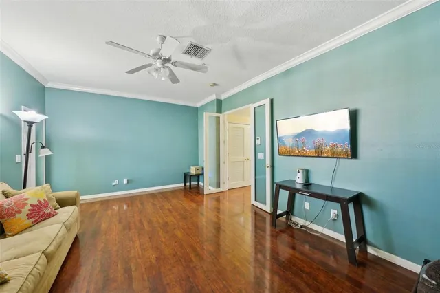 an empty room with wooden floor and windows