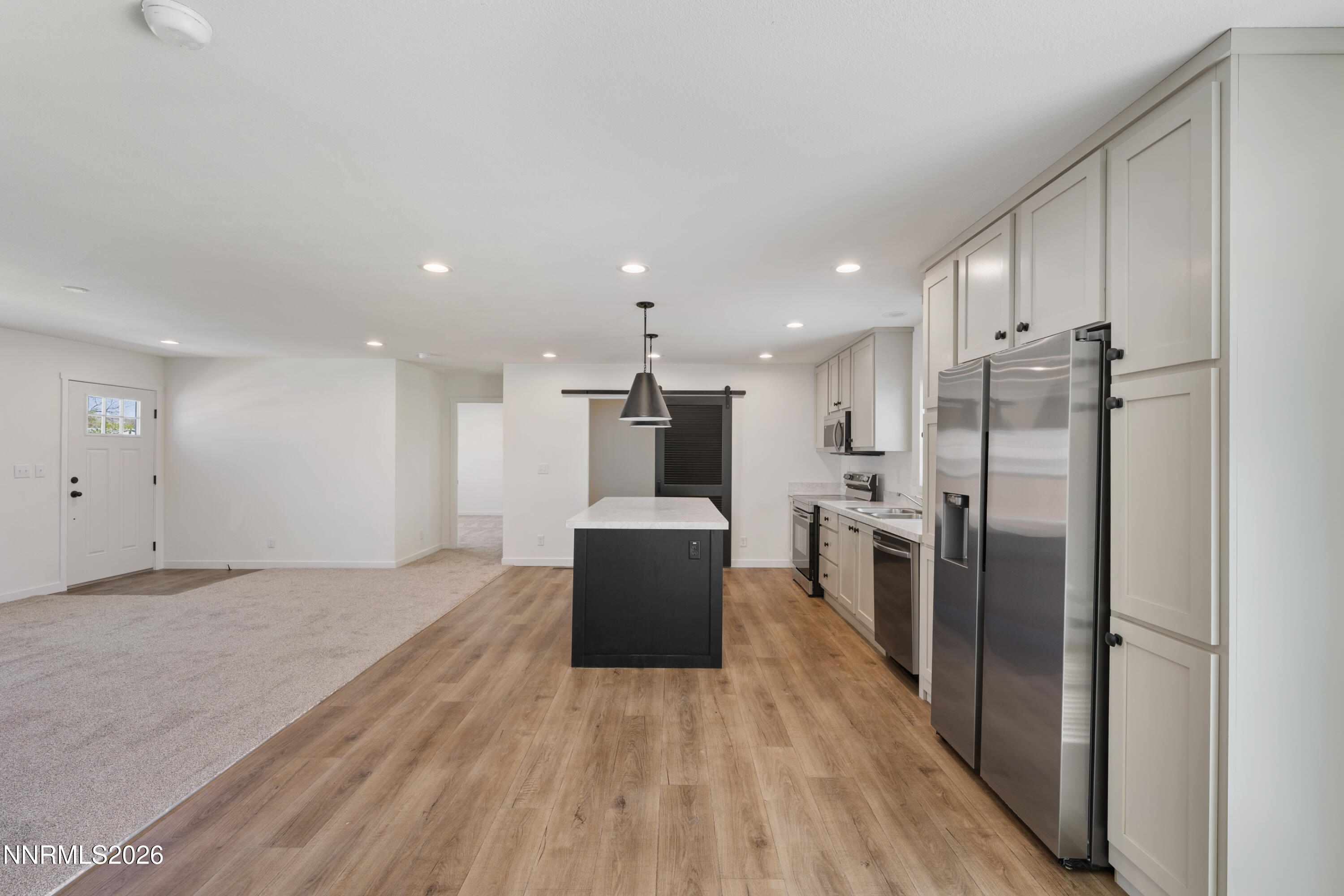 242 Caleb Court Sun Valley, NV 89433 - Photo 11 of 24 a kitchen with stainless steel appliances a refrigerator and a stove top oven