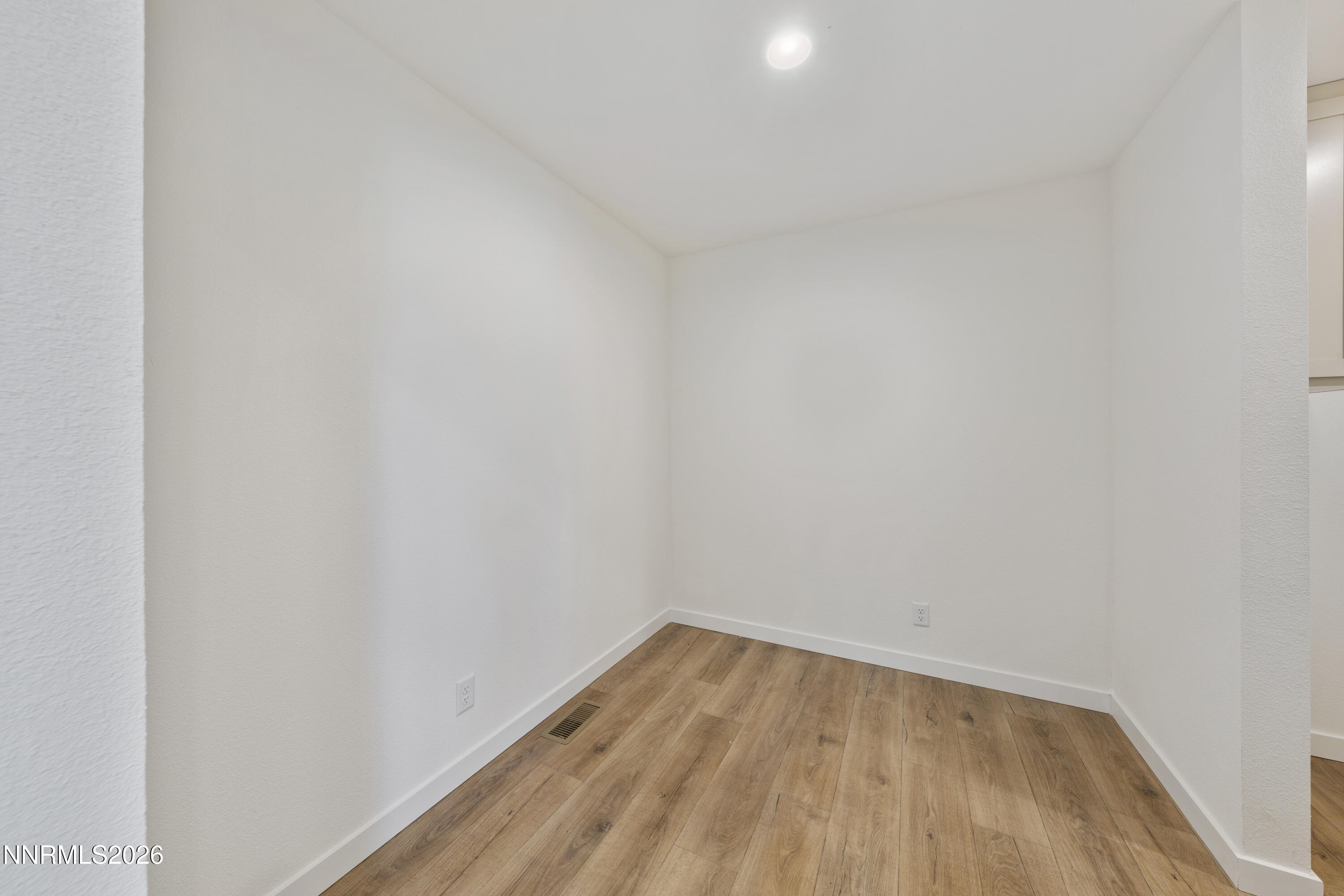 242 Caleb Court Sun Valley, NV 89433 - Photo 14 of 24 a view of a room that has wooden floor and white walls