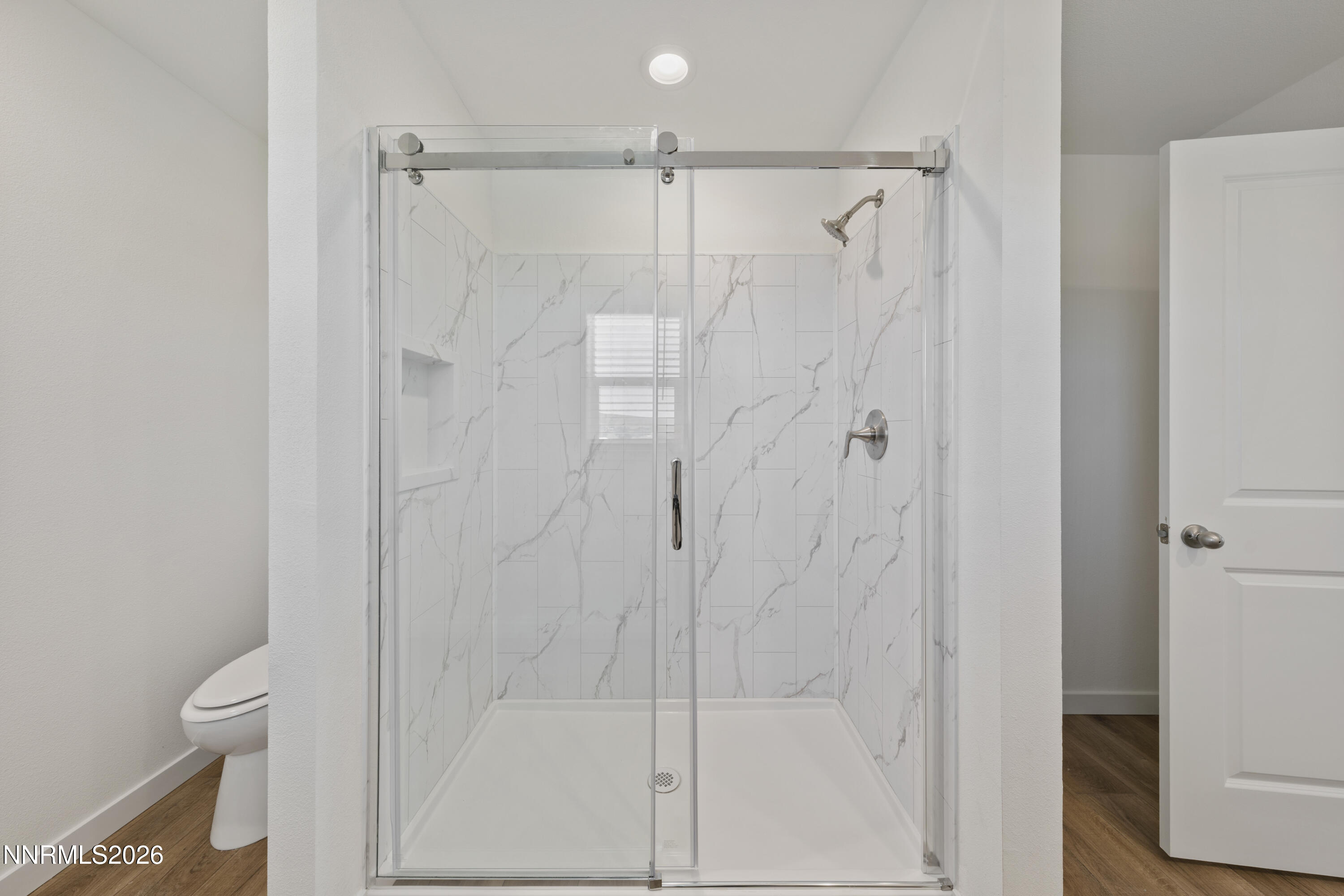 242 Caleb Court Sun Valley, NV 89433 - Photo 19 of 24 a bathroom with a shower and a toilet