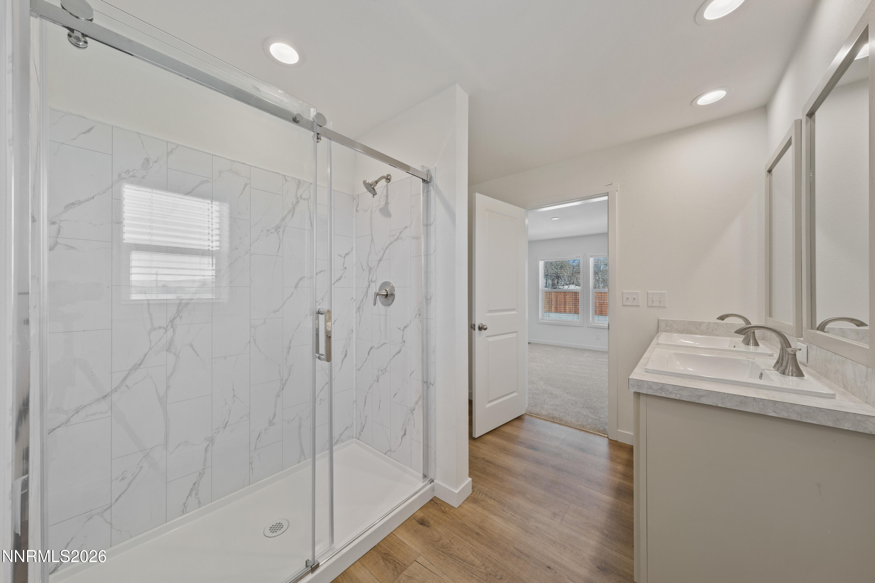 242 Caleb Court Sun Valley, NV 89433 - Photo 20 of 24 a bathroom with a granite countertop sink a toilet and shower