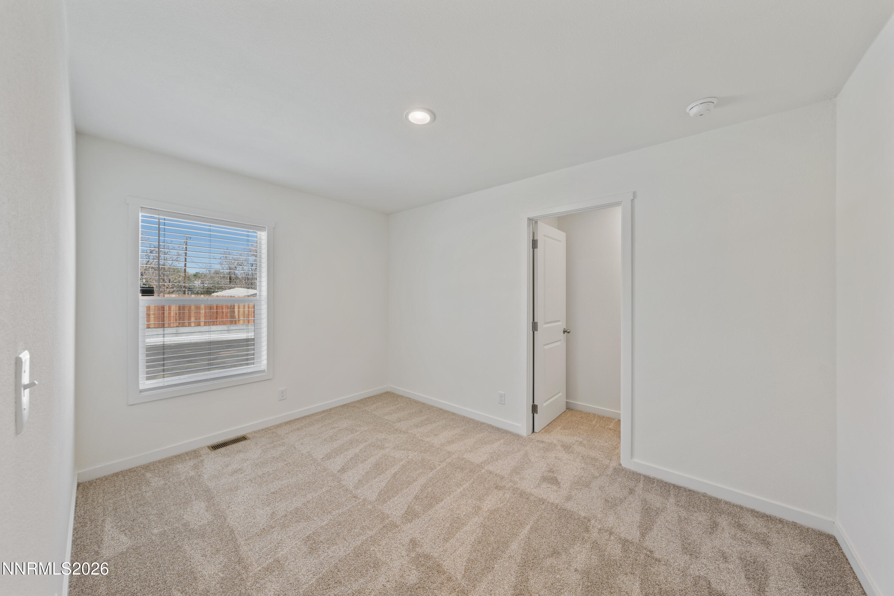242 Caleb Court Sun Valley, NV 89433 - Photo 21 of 24 a view of an empty room with a window