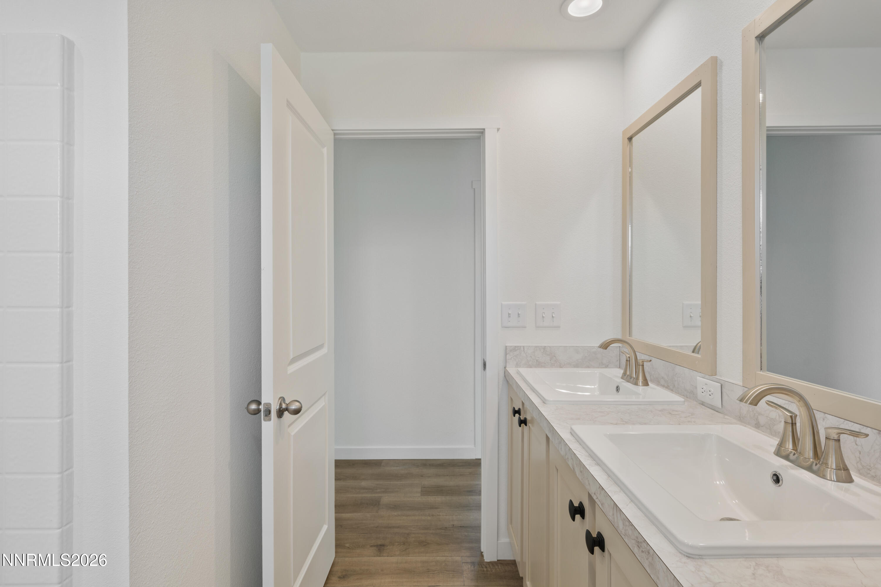 242 Caleb Court Sun Valley, NV 89433 - Photo 23 of 24 a bathroom with a sink and mirror
