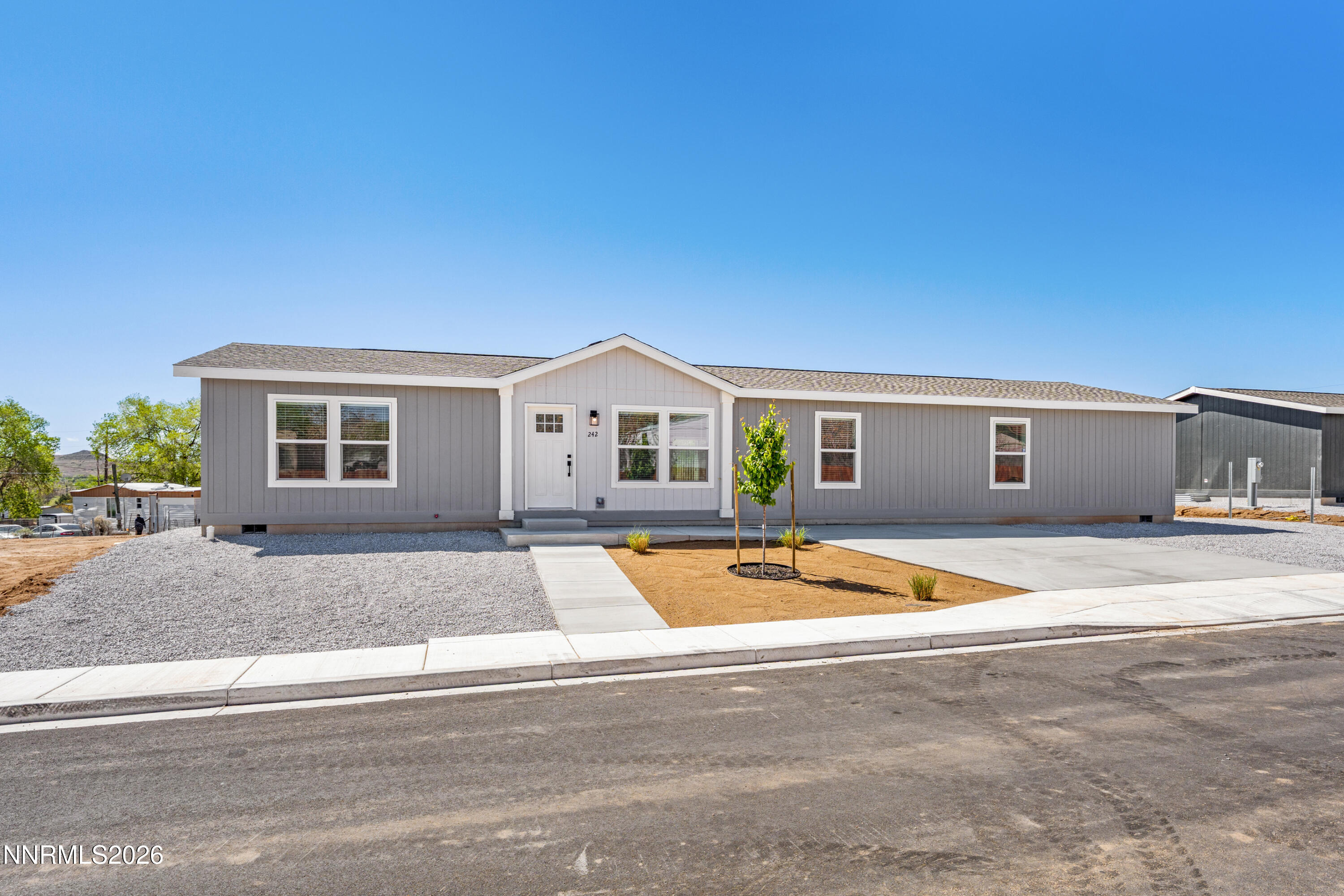 242 Caleb Court Sun Valley, NV 89433 - Photo 24 of 24 a front view of a house with yard and ocean view