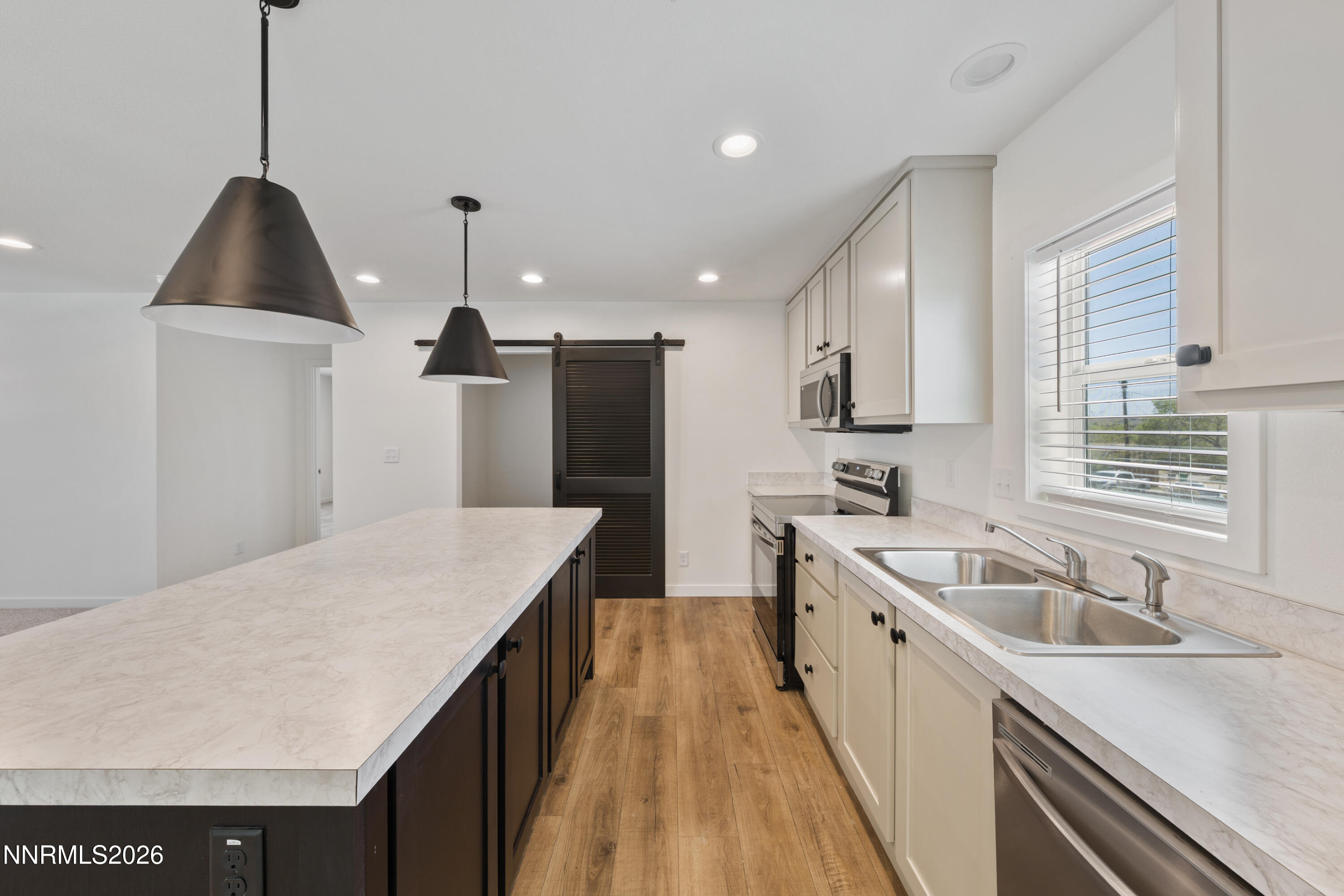 242 Caleb Court Sun Valley, NV 89433 - Photo 4 of 24 a kitchen with a sink stove and refrigerator