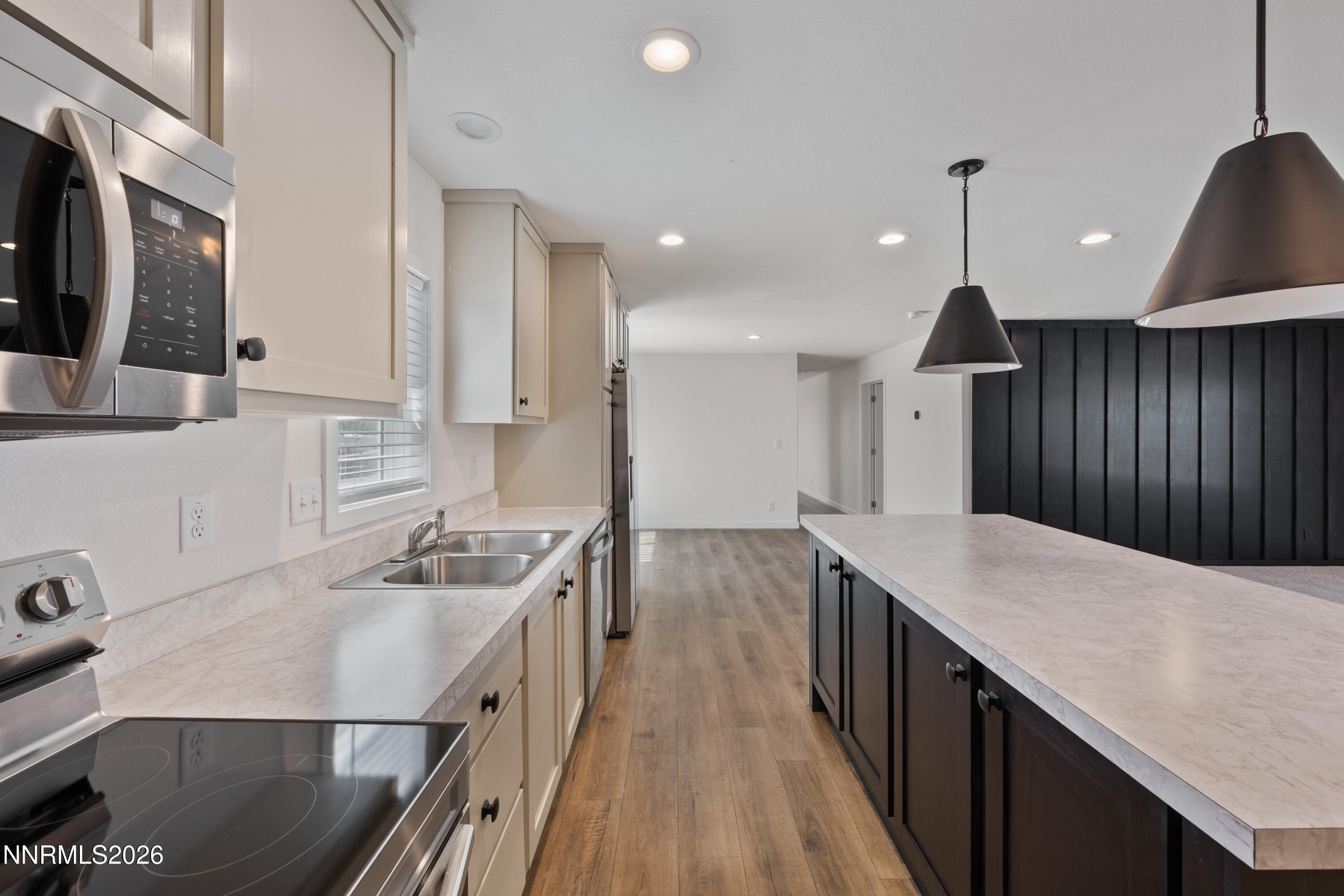242 Caleb Court Sun Valley, NV 89433 - Photo 5 of 24 a kitchen with a sink a stove and a refrigerator