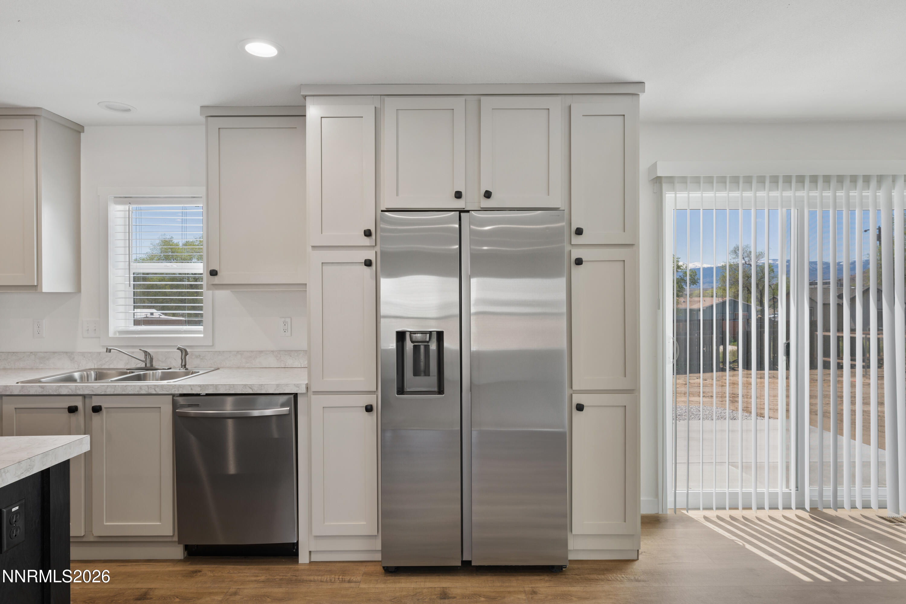 242 Caleb Court Sun Valley, NV 89433 - Photo 8 of 24 a kitchen with stainless steel appliances granite countertop a refrigerator and a sink
