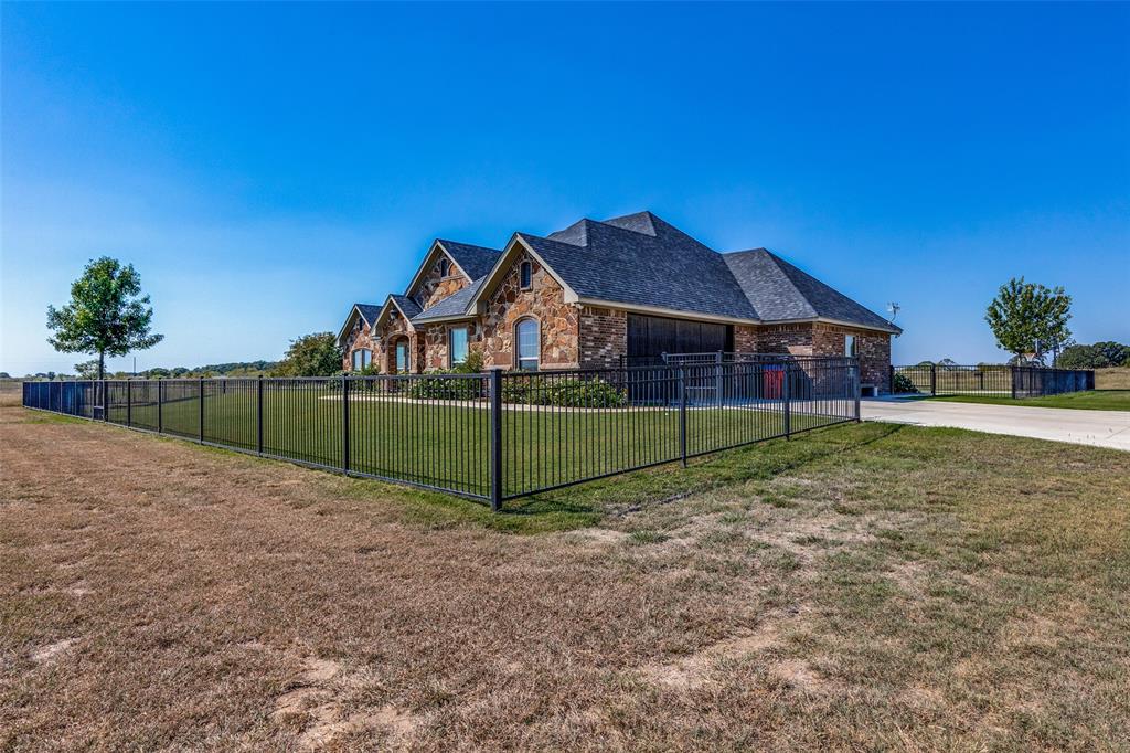 1150 Lone Star Road Bowie, TX 76230 - Photo 4 of 38 a view of a house with a backyard
