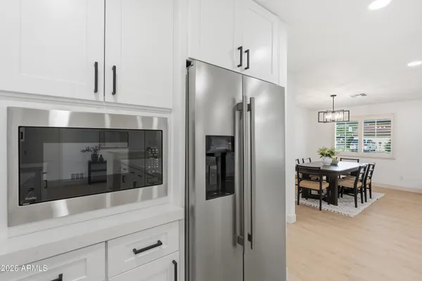 a kitchen with stainless steel appliances granite countertop a refrigerator and a stove top oven