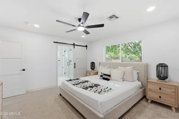 a bedroom with a bed and a window