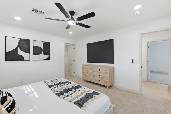 a bedroom with a bed and a flat screen tv