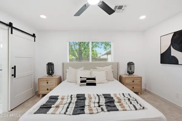 a bedroom with a bed and a window