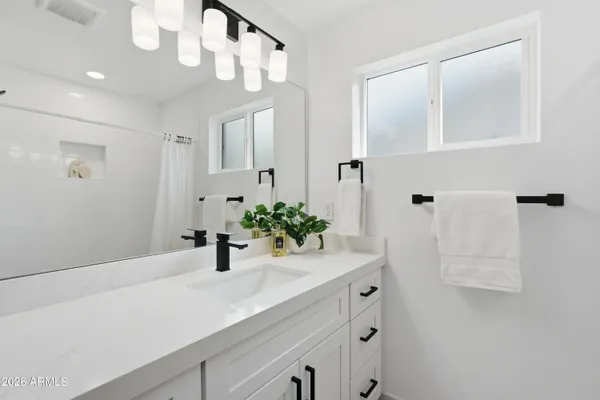 a bathroom with a sink and a mirror