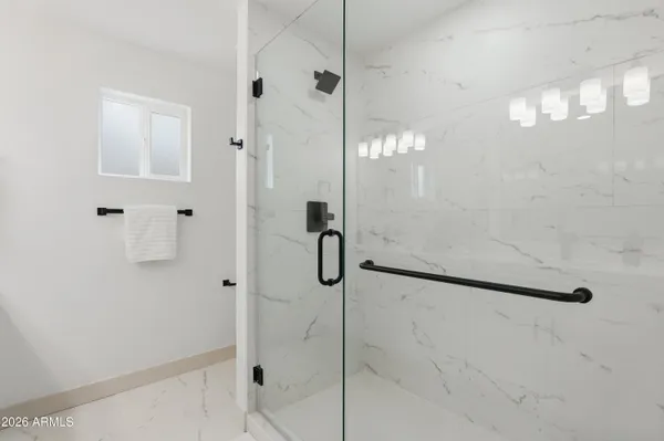 a bathroom with a glass shower door